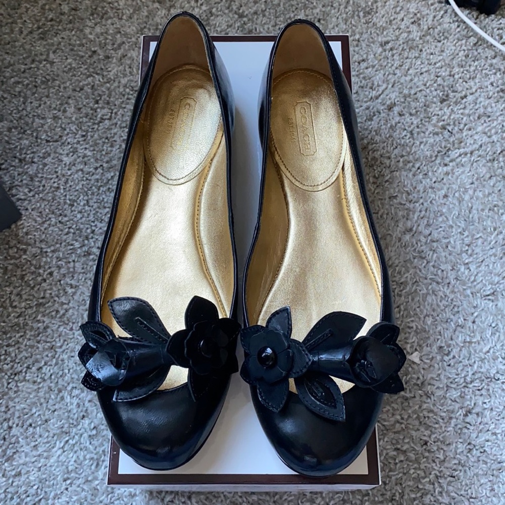 COACH Chrisann patent leather flats with floral appliqué.